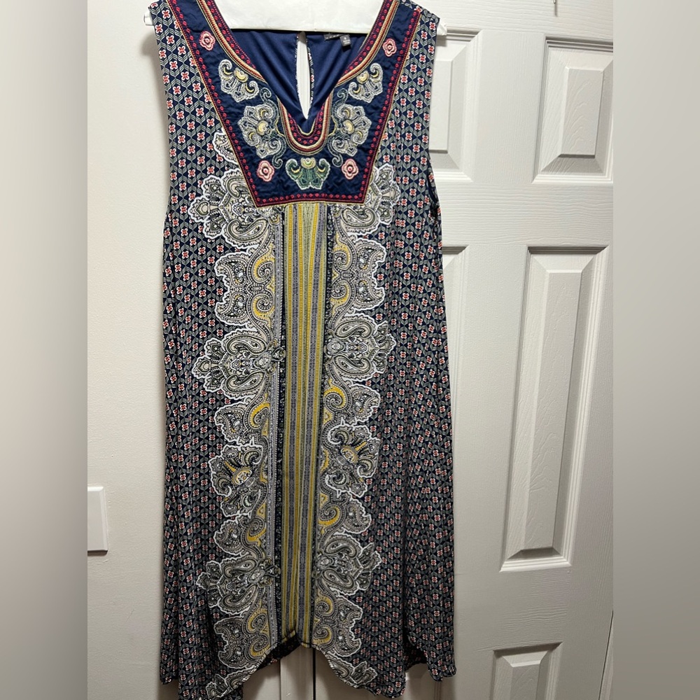 Women’s dress from  Luxology  with an  embroidered v-neck.